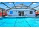 A refreshing blue swimming pool with an enclosed patio for relaxation and entertainment at 235 Hidden Springs Cir, Kissimmee, FL 34743