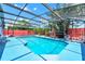Inviting screened-in pool area, surrounded by a concrete deck and mature landscaping at 235 Hidden Springs Cir, Kissimmee, FL 34743