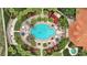 Aerial view of the community pool featuring ample seating and umbrellas surrounded by lush landscaping at 255 Cordova Ave, Davenport, FL 33897