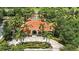 An aerial view of the community clubhouse featuring a terracotta tile roof and lush landscaping at 255 Cordova Ave, Davenport, FL 33897