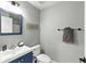Cozy bathroom featuring a vanity, toilet, mirror, and decorative beach accents at 255 Cordova Ave, Davenport, FL 33897