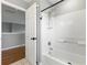 Bright bathroom with a white tiled shower and tub, with modern fixtures and neutral walls at 255 Cordova Ave, Davenport, FL 33897