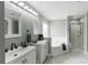 Bright bathroom with dual vanities, soaking tub, and separate glass-enclosed shower at 255 Cordova Ave, Davenport, FL 33897