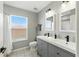 Well-lit bathroom with a double sink vanity, modern fixtures, and a shower-tub combination at 255 Cordova Ave, Davenport, FL 33897