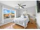 Well-lit bedroom with a ceiling fan, window with backyard view, and wood laminate flooring at 255 Cordova Ave, Davenport, FL 33897