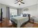 Comfortable bedroom with a ceiling fan, window, and stylish decor at 255 Cordova Ave, Davenport, FL 33897