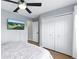 Bedroom with a ceiling fan, tv and closet for storage and wood laminate flooring at 255 Cordova Ave, Davenport, FL 33897