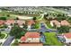 An aerial view of a beautiful home with a screened-in pool and manicured lawn at 255 Cordova Ave, Davenport, FL 33897