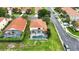 An aerial view of a backyard, featuring a screened-in pool and well-manicured lawn at 255 Cordova Ave, Davenport, FL 33897