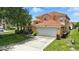 Lovely single-Gathering home featuring a terracotta tile roof, two car garage, and well-manicured lawn at 255 Cordova Ave, Davenport, FL 33897