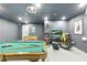 Spacious game room features a pool table, foosball table, and arcade games for entertainment at 255 Cordova Ave, Davenport, FL 33897