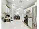 Bright kitchen boasts white cabinets, stainless steel appliances, and expansive quartz countertops at 255 Cordova Ave, Davenport, FL 33897