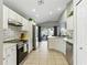 Modern kitchen featuring white cabinets, stainless steel appliances, tile backsplash, and a view of the backyard at 255 Cordova Ave, Davenport, FL 33897