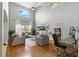 Cozy living room featuring high ceilings, wood floors, comfortable gray seating, and a bright window at 255 Cordova Ave, Davenport, FL 33897