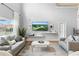Bright living room with high ceilings, large windows, neutral tones, and comfortable seating at 255 Cordova Ave, Davenport, FL 33897