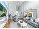 Spacious living room showcasing wood floors, high ceilings, a staircase, and a seamless transition into the kitchen at 255 Cordova Ave, Davenport, FL 33897