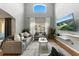 Bright living room with high ceilings, large windows, hardwood floors, and comfortable seating arrangements at 255 Cordova Ave, Davenport, FL 33897
