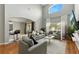 Open living room with high ceilings, wood floors, comfortable seating, and a view into the kitchen at 255 Cordova Ave, Davenport, FL 33897