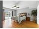 Main bedroom boasts a ceiling fan, wood floors, and sliding glass doors to the pool at 255 Cordova Ave, Davenport, FL 33897