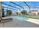 Inviting screened pool with clear blue water and ample space for outdoor furniture at 255 Cordova Ave, Davenport, FL 33897