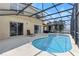 Backyard pool area featuring a spa, sun loungers, and outdoor living space at 255 Cordova Ave, Davenport, FL 33897