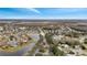 Aerial view of the community with its serene pond and houses nestled among trees at 2556 Volta Cir, Kissimmee, FL 34746
