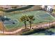 Aerial view of the community basketball court with palm trees and benches at 2556 Volta Cir, Kissimmee, FL 34746