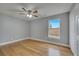 Cozy bedroom with hardwood floors, ceiling fan, a double closet and ample natural light at 2556 Volta Cir, Kissimmee, FL 34746