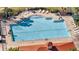 Aerial view of the community pool, complete with lounge chairs, tables, and well-kept surroundings at 2556 Volta Cir, Kissimmee, FL 34746