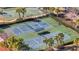 Aerial view of the community's tennis and basketball courts, surrounded by palm trees at 2556 Volta Cir, Kissimmee, FL 34746