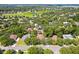 Aerial view of a residential neighborhood with mature trees, lawns, and a nearby pond at 2613 Breezy Meadow Rd, Apopka, FL 32712