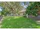 This backyard has a lush lawn and mature landscaping at 2613 Breezy Meadow Rd, Apopka, FL 32712