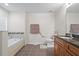 Spacious bathroom with a soaking tub and vanity with granite countertop at 2613 Breezy Meadow Rd, Apopka, FL 32712