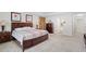 Spacious carpeted primary bedroom featuring an ensuite bathroom and bedside tables with lamps at 2613 Breezy Meadow Rd, Apopka, FL 32712
