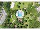Overhead view of the community pool, showcasing lounge chairs, beach volleyball court, and lush landscaping at 2613 Breezy Meadow Rd, Apopka, FL 32712