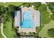 Relaxing community pool with clear blue water, covered seating, and well-maintained landscaping at 2613 Breezy Meadow Rd, Apopka, FL 32712