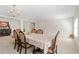 Dining room features neutral paint and carpet, large table with patterned chairs, and natural light at 2613 Breezy Meadow Rd, Apopka, FL 32712