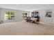 Large dining area with neutral carpet, bright windows, and an elegant dining table at 2613 Breezy Meadow Rd, Apopka, FL 32712