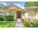Charming single-story home featuring a covered front porch, manicured hedges, and sidewalk path at 2613 Breezy Meadow Rd, Apopka, FL 32712