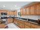 Functional kitchen with granite countertops, stainless steel appliances, and extensive cabinet space at 2613 Breezy Meadow Rd, Apopka, FL 32712