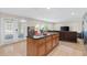 Open kitchen featuring a center island, stainless appliances, and seamless access to the living room at 2613 Breezy Meadow Rd, Apopka, FL 32712