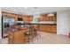 Stylish kitchen with granite countertops, stainless steel appliances, and a central island with seating at 2613 Breezy Meadow Rd, Apopka, FL 32712
