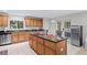 Spacious kitchen with a large island, stainless steel appliances, and plenty of cabinet storage at 2613 Breezy Meadow Rd, Apopka, FL 32712