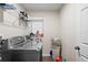 The laundry room features a washer, dryer, and shelves at 2613 Breezy Meadow Rd, Apopka, FL 32712