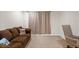 This living room features a sofa and an office chair at 2613 Breezy Meadow Rd, Apopka, FL 32712