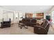 Cozy living room with an open layout, featuring leather seating and neutral tones at 2613 Breezy Meadow Rd, Apopka, FL 32712