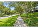 Charming tree-lined street with sidewalk, showcasing the serene neighborhood setting at 2613 Breezy Meadow Rd, Apopka, FL 32712