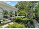 Backyard retreat featuring a hot tub, lush landscaping, and elegant sculpture at 2781 Stanfield Ave, Orlando, FL 32814
