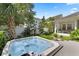 Beautiful backyard featuring a hot tub, lush landscaping, and mature trees at 2781 Stanfield Ave, Orlando, FL 32814