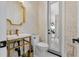 Stylish bathroom with gold accents, patterned wallpaper, and modern vanity at 2781 Stanfield Ave, Orlando, FL 32814